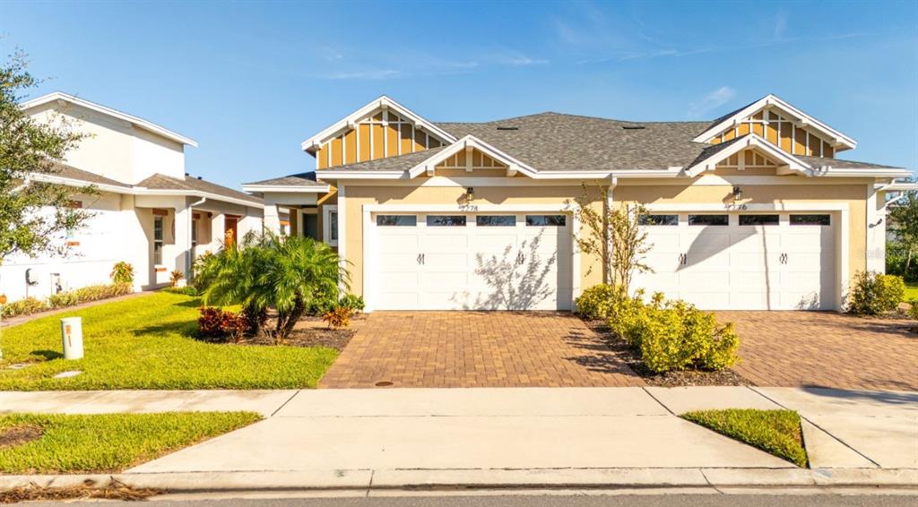 2278 Datura Loop St. Cloud, FL 34772 - Photo 2 of 31 a view of a white house with a small yard and plants