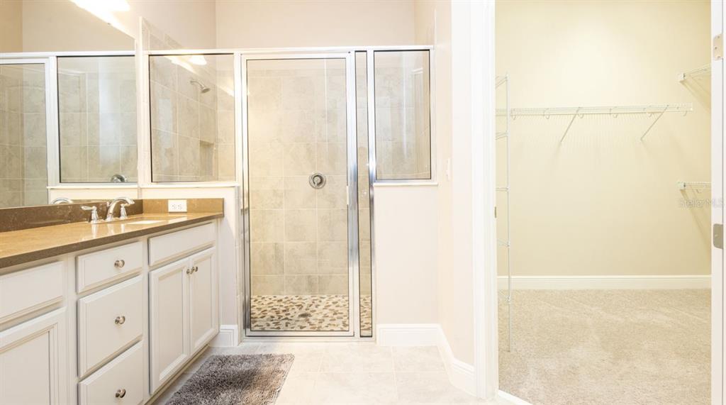 2278 Datura Loop St. Cloud, FL 34772 - Photo 21 of 31 a bathroom with a double vanity sink and a mirror