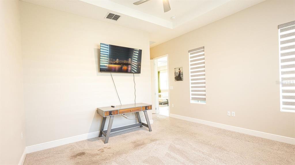 2278 Datura Loop St. Cloud, FL 34772 - Photo 23 of 31 a living room with a chair and a flat screen tv