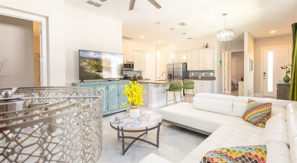 2278 Datura Loop St. Cloud, FL 34772 - Photo 7 of 31 a living room with furniture and a chandelier