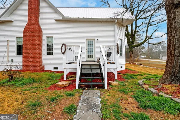 a front view of a house with garden