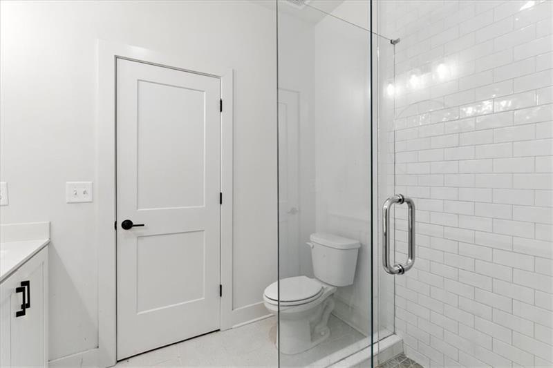 170 Color Circle Atlanta, GA 30317 - Photo 18 of 34 a bathroom with a toilet and shower