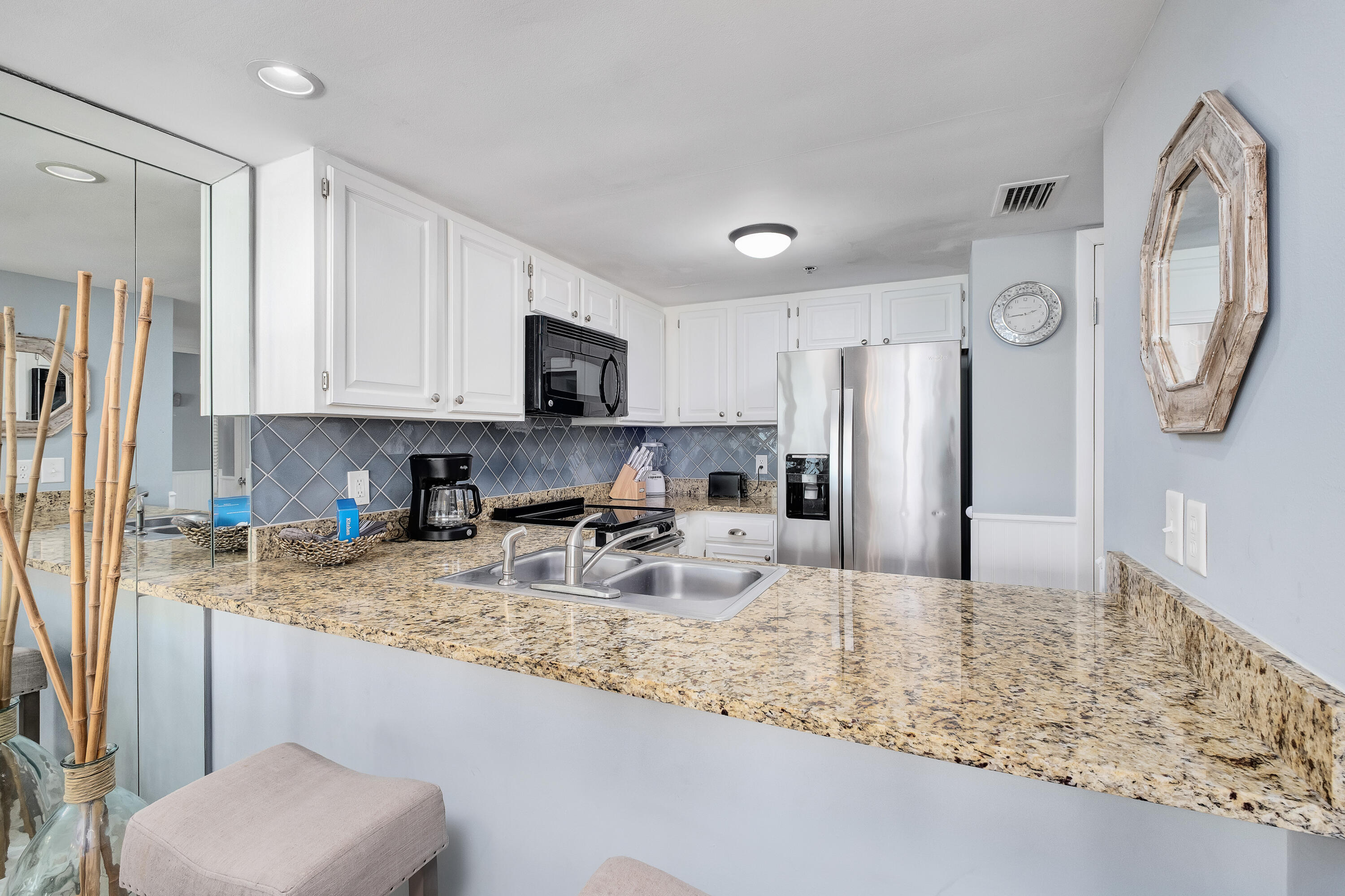 4100 East County Highway 30A, Unit 902 Santa Rosa Beach, FL 32459 - Photo 13 of 54 a kitchen with stainless steel appliances granite countertop a sink a stove a microwave a refrigerator and cabinets