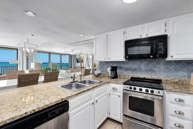 a kitchen with a sink a stove and a wooden cabinets