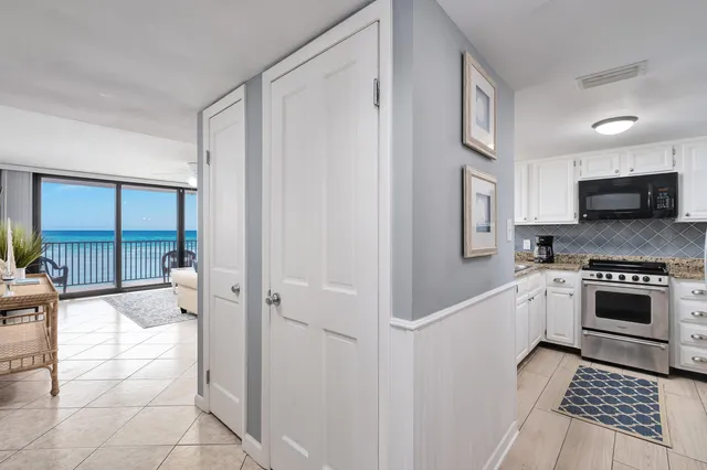 a living room with furniture and kitchen view