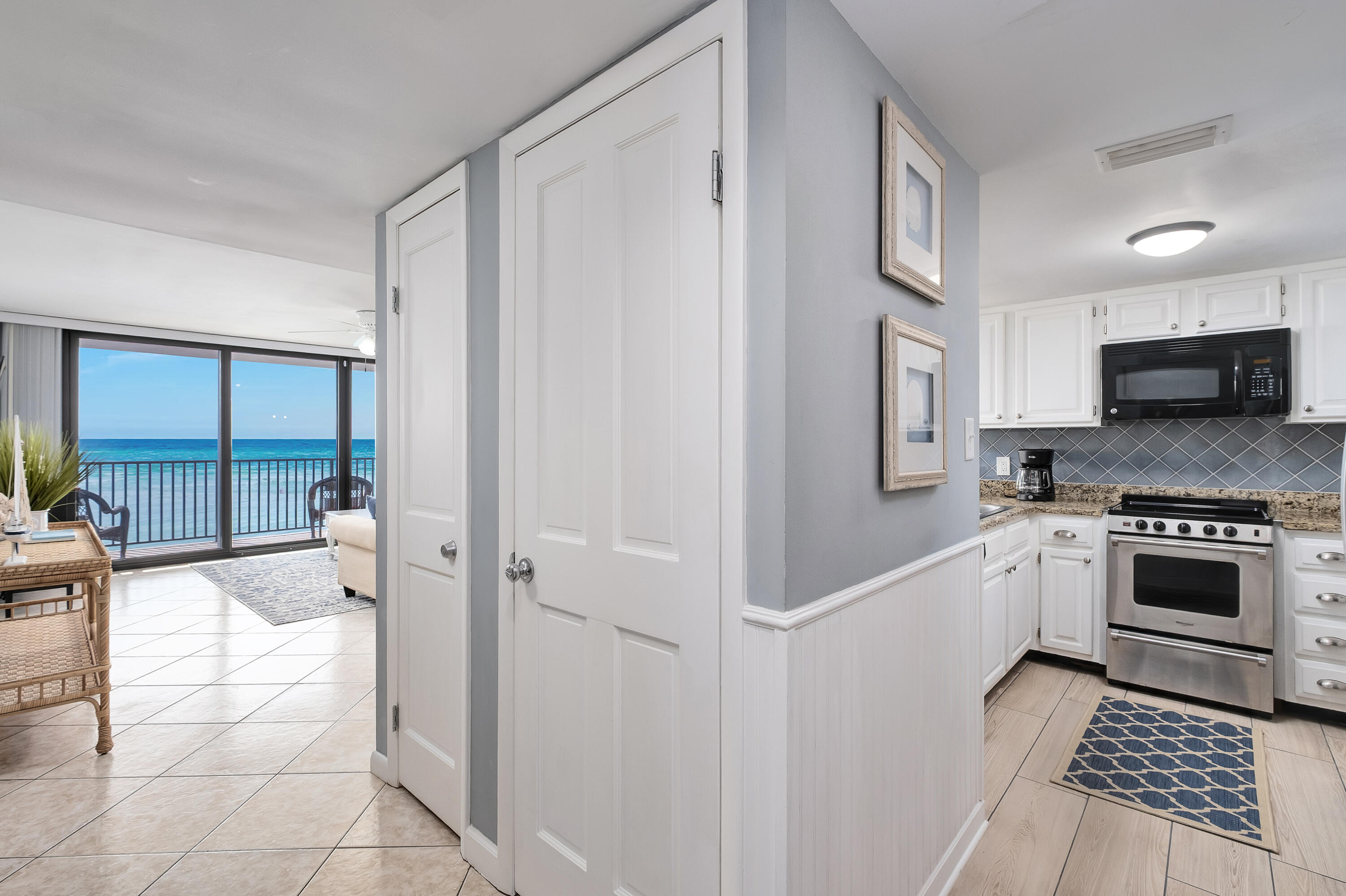 4100 East County Highway 30A, Unit 902 Santa Rosa Beach, FL 32459 - Photo 7 of 54 a kitchen with granite countertop a stove a sink and a refrigerator