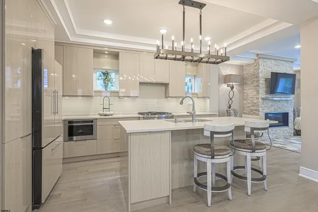 a kitchen with a center island and stainless steel appliances