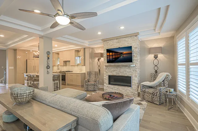 a living room with furniture a fireplace and a flat screen tv