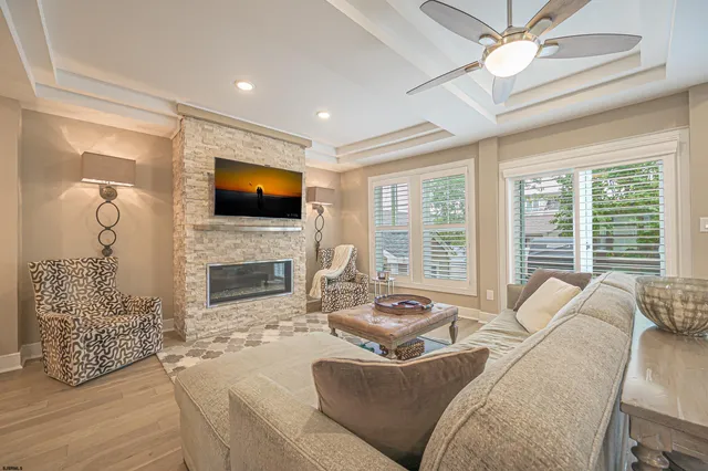 a living room with furniture a fireplace and a flat screen tv