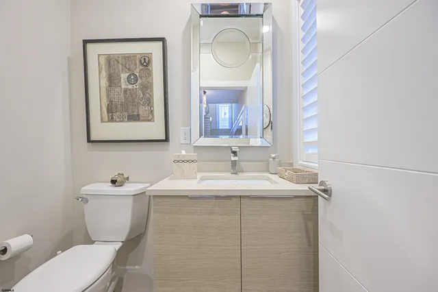 a bathroom with a toilet sink and mirror