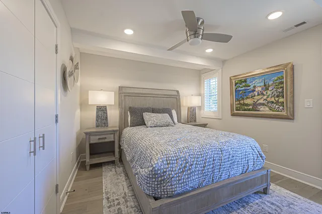a bedroom with a large bed and a chandelier