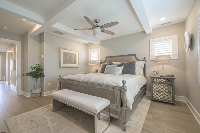 a bedroom with a bed and windows