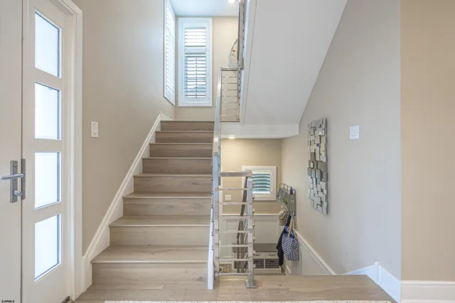 a view of entryway with wooden floor and a front door