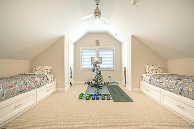 a bedroom with a bed and dresser with mirror