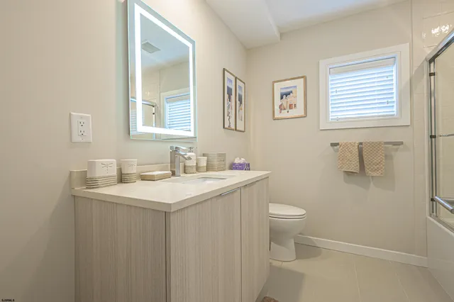 a bathroom with a sink toilet and a mirror