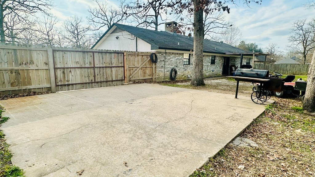 235 Spring Branch Street Lufkin, TX 75904 - Photo 28 of 30 a backyard of a house with table and chairs
