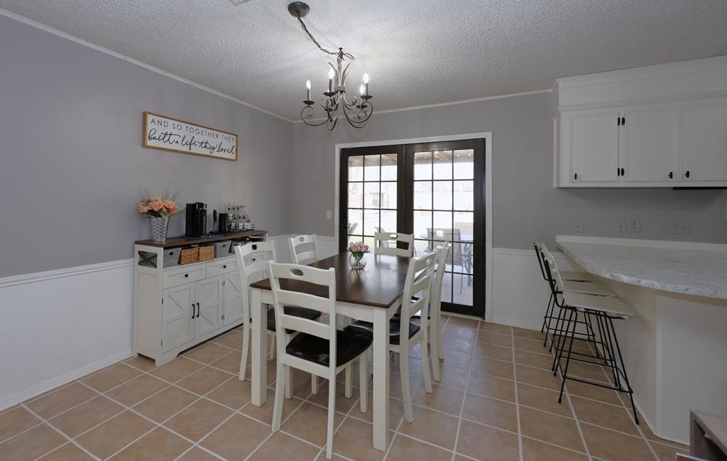 235 Spring Branch Street Lufkin, TX 75904 - Photo 8 of 30 a view of a dining room with furniture and chandelier