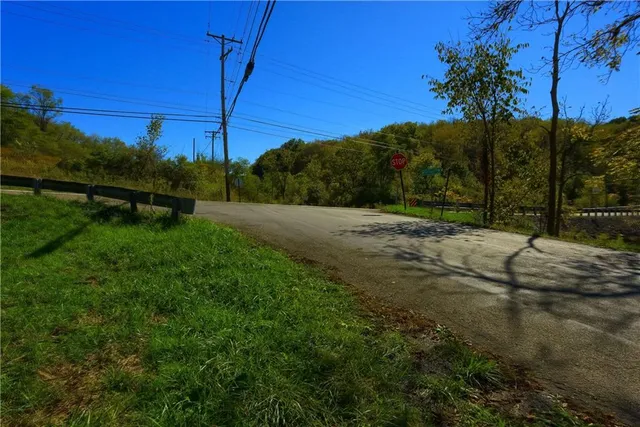 a view of a street with a yard