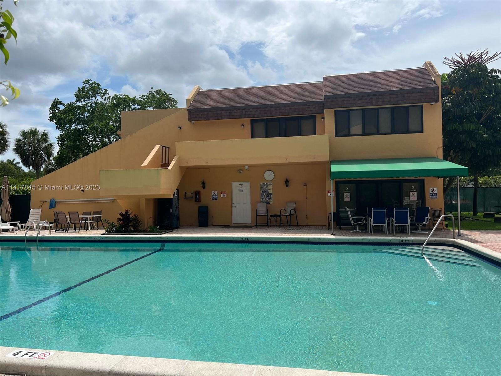 450 Commodore Drive, Unit 211 Plantation, FL 33325 - Photo 11 of 12 a front view of a building with a garden