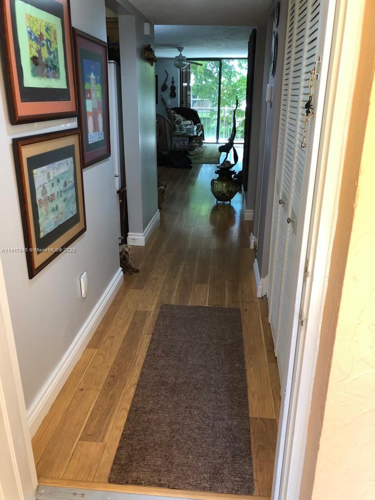 450 Commodore Drive, Unit 211 Plantation, FL 33325 - Photo 8 of 12 a view of hallway with furniture and a window