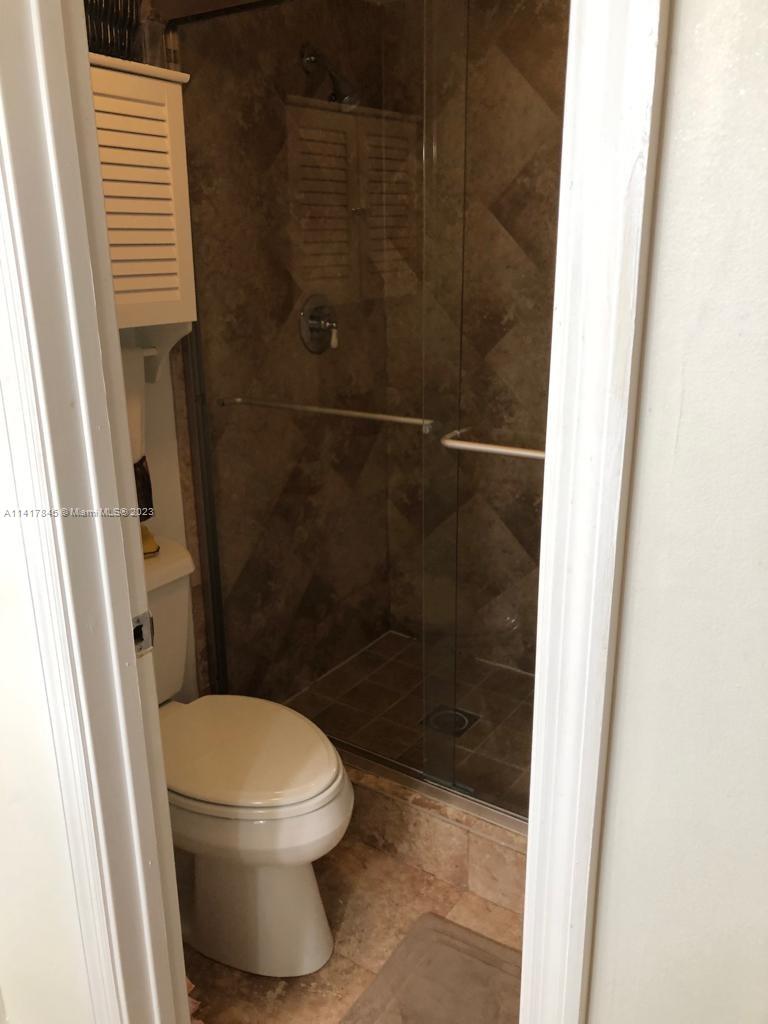 450 Commodore Drive, Unit 211 Plantation, FL 33325 - Photo 10 of 12 a bathroom with a toilet and a shower