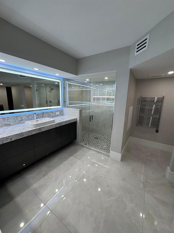 2051 Southeast 3rd Street, Unit 406 Deerfield Beach, FL 33441 - Photo 13 of 61 a bathroom with a double vanity sink and mirror