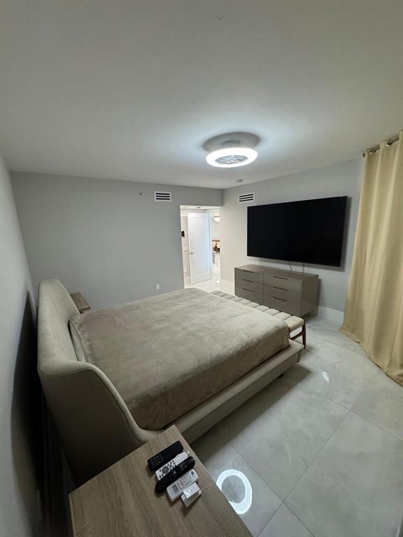 2051 Southeast 3rd Street, Unit 406 Deerfield Beach, FL 33441 - Photo 17 of 61 a bedroom with a bed and a television