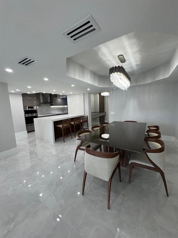 2051 Southeast 3rd Street, Unit 406 Deerfield Beach, FL 33441 - Photo 20 of 61 a living room with furniture a dining table and kitchen view