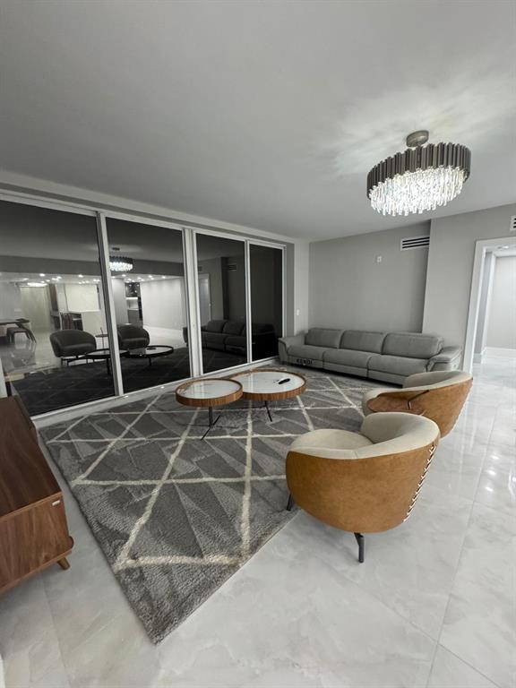 2051 Southeast 3rd Street, Unit 406 Deerfield Beach, FL 33441 - Photo 22 of 61 a living room with gym equipment