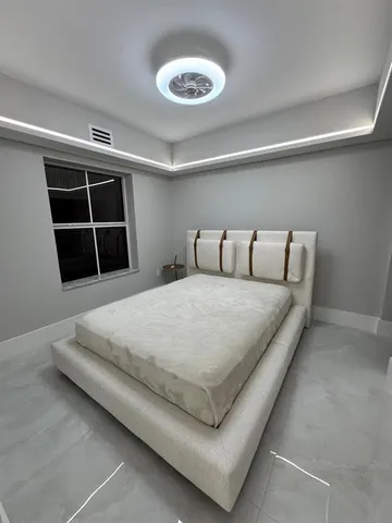 a large kitchen with stainless steel appliances a large counter top