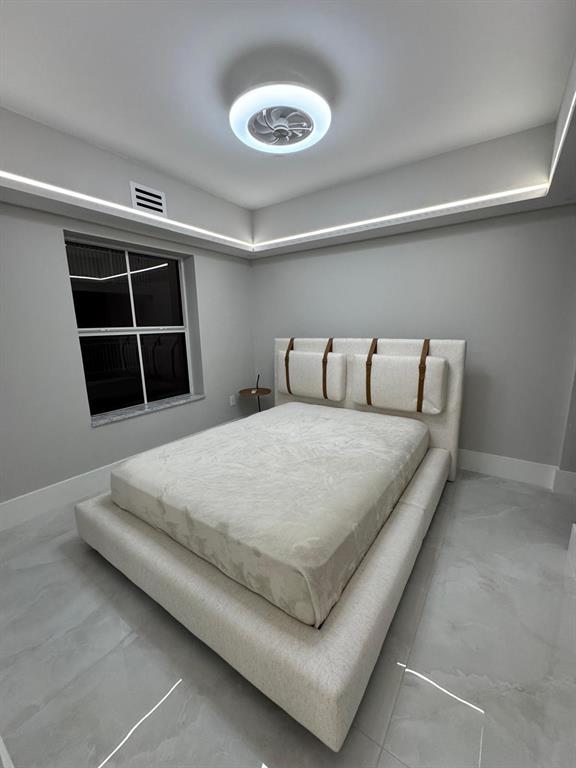 2051 Southeast 3rd Street, Unit 406 Deerfield Beach, FL 33441 - Photo 27 of 61 a bedroom with a bed and a window