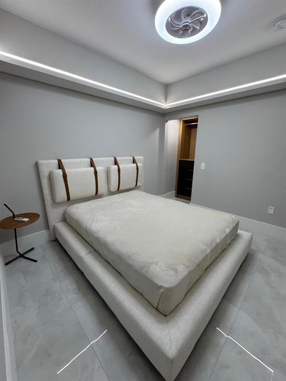 2051 Southeast 3rd Street, Unit 406 Deerfield Beach, FL 33441 - Photo 28 of 61 a bed sitting in a bedroom and a night stand