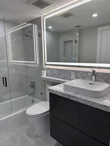 a lobby with furniture and a ceiling fan