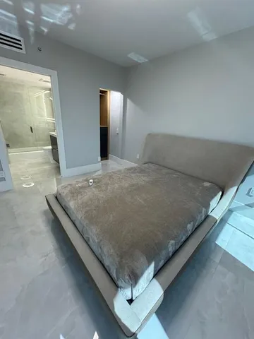 a view of an empty room with kitchen