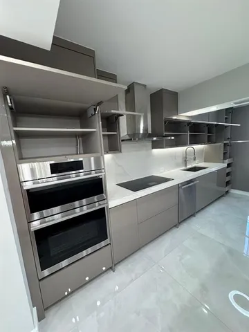 a view of a refrigerator a window and an empty room