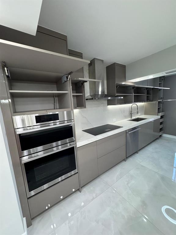 2051 Southeast 3rd Street, Unit 406 Deerfield Beach, FL 33441 - Photo 42 of 61 a kitchen with appliances cabinets and a sink