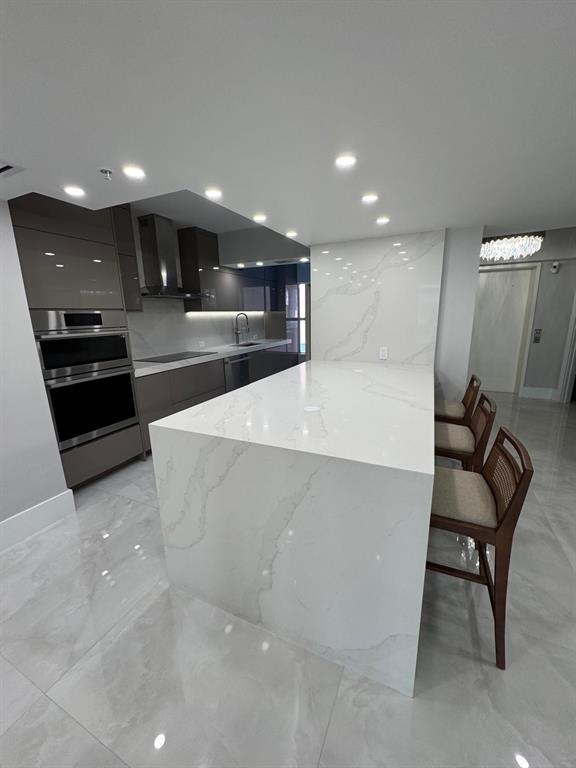 2051 Southeast 3rd Street, Unit 406 Deerfield Beach, FL 33441 - Photo 43 of 61 a large white kitchen with stainless steel appliances