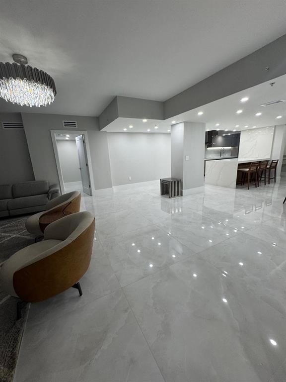 2051 Southeast 3rd Street, Unit 406 Deerfield Beach, FL 33441 - Photo 46 of 61 a lobby with furniture and a ceiling fan