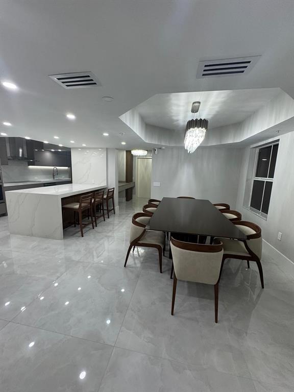 2051 Southeast 3rd Street, Unit 406 Deerfield Beach, FL 33441 - Photo 47 of 61 a living room with a table and chairs