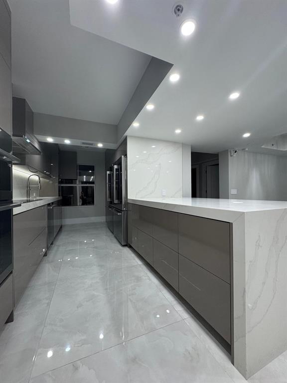 2051 Southeast 3rd Street, Unit 406 Deerfield Beach, FL 33441 - Photo 50 of 61 a view of an empty room with kitchen