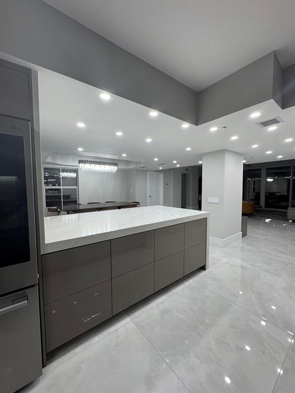 2051 Southeast 3rd Street, Unit 406 Deerfield Beach, FL 33441 - Photo 52 of 61 a large bathroom with a large mirror and a sink