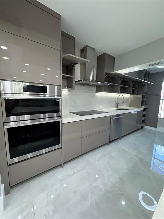 2051 Southeast 3rd Street, Unit 406 Deerfield Beach, FL 33441 - Photo 53 of 61 a kitchen with stainless steel appliances a stove a microwave and a hard wood floor