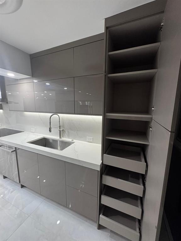 2051 Southeast 3rd Street, Unit 406 Deerfield Beach, FL 33441 - Photo 54 of 61 a kitchen with cabinets and a sink