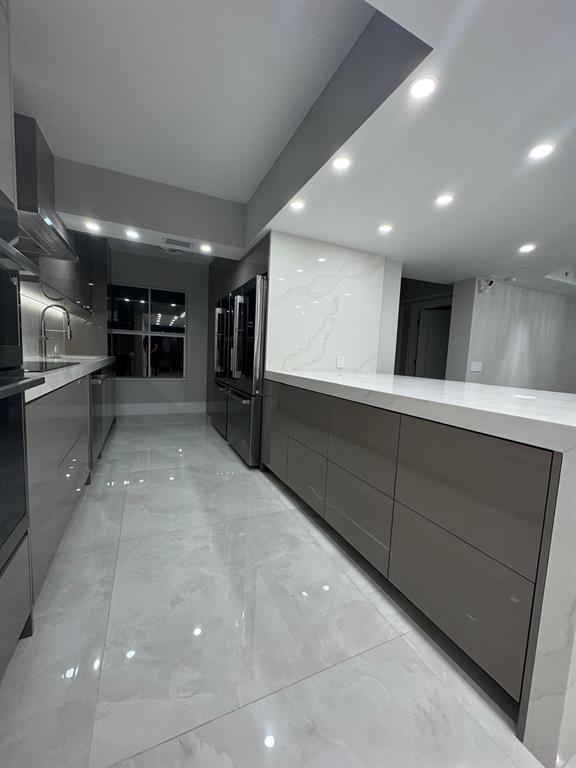 2051 Southeast 3rd Street, Unit 406 Deerfield Beach, FL 33441 - Photo 59 of 61 a view of an empty room with a fireplace