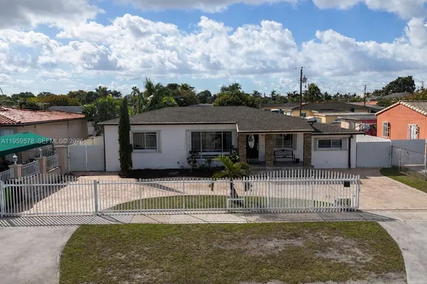 a view of a house with swimming pool and a yard