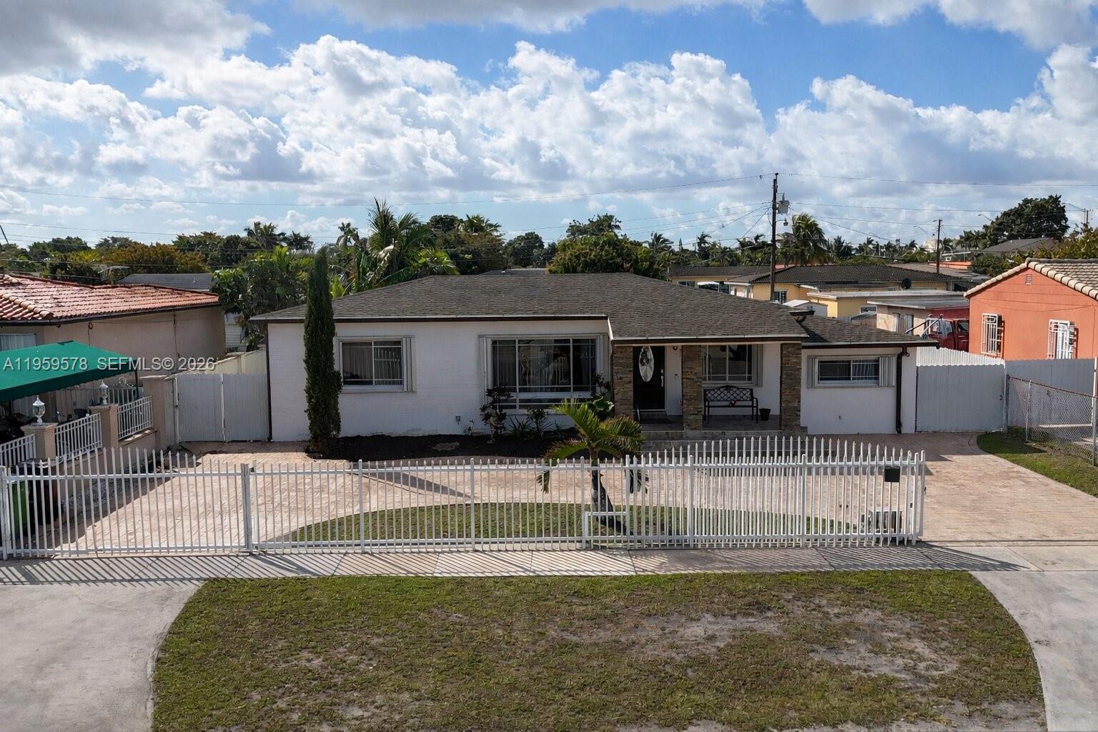 360 West 55th Street Hialeah, FL 33012 - Photo 1 of 20 a view of a house with swimming pool and a yard