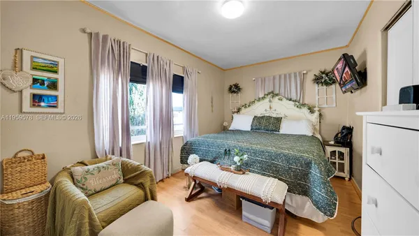 a bedroom with furniture and a window
