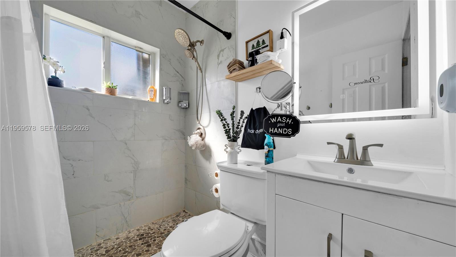 360 West 55th Street Hialeah, FL 33012 - Photo 13 of 20 a bathroom with a sink a toilet and shower