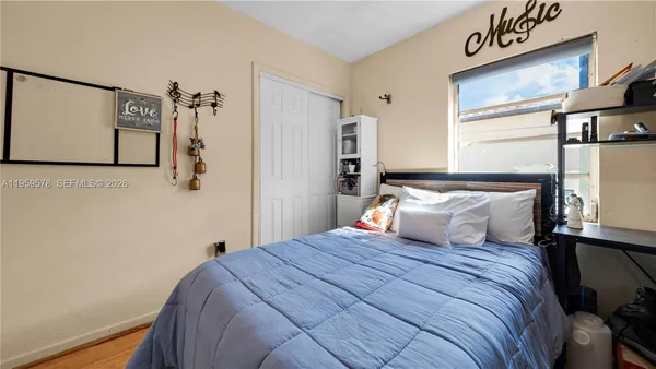 a bedroom with a large bed and a window