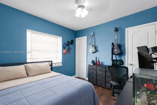 a bedroom with a bed and flat screen tv